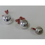 A graduated set of three silver baubles hallmarked 2000