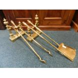 A set of three Victorian brass fire tools together with a pair of brass fire dogs of Neo Classical