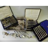 A collection of various silver napkin rings together with a silver pedestal Adams style pepperette,