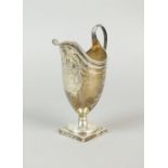 A George III silver helmet cream jug, London 1792, with bright cut engraved decoration and initials,