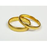 Two plain polished 22ct gold wedding bands, total weight 7.