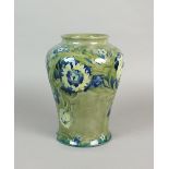 A Moorcroft 'Florian' ware vase of high shouldered tapering form picked out with a mixed flower