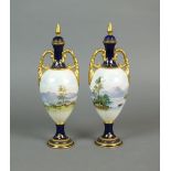 A pair of Coalport porcelain two handled panoramic landscape vases and covers,