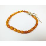 A graduated amber bead bracelet, weight 10.