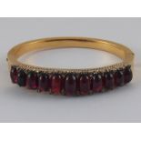 An antique gold cabochon garnet and diamond bracelet with silver settings,