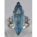 A fine white metal (tests 18 carat gold) aquamarine and diamond ring,