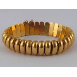 A yellow metal (tests 18 carat gold) bracelet, approx 19cm long, 1.5cm wide, approx 46.8 gms.