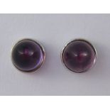 A pair of 18 carat white gold cabochon amethyst earrings by Garrard, approx 6mm diameter, 1.5 gms.