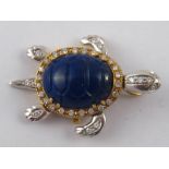 A yellow metal (tests 18 carat gold) diamond and carved lapis lazuli necklace clasp,