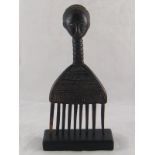 A Fang tribe comb, Gabon, on stand. 28x12cm.