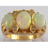 An 18 carat gold opal and diamond ring, hallmarked London 1975,