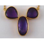 A yellow metal (tests 18 carat gold) amethyst pendant necklace, largest amethyst approx 19 x 9mm,