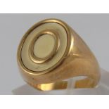 A 9 carat gold and cream enamel ring, size M, 11.5 gms.