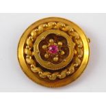 A yellow metal (tests 18 carat gold) circle brooch, approx 37mm wide, 11.8 gms.