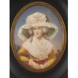 A 19th. century oval miniature of a lady with large hat in ebony frame. Miniature 6.5x8.5cm.