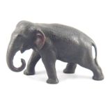 A Japanese bronze elephant, ivory tusks missing, cast seal signature. 17cm. long.