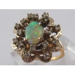 A yellow metal (tests 14 carat gold) opal and diamond ring, opal approx 9 x 6mm, ring size L, 6.