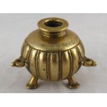 A cast bronze spherical inkwell on three pad feet with possibly Saudi script. 9cm. high.