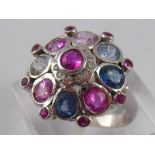 A white metal (tests 18 carat gold)pink, blue and white sapphire ring, head approx 17.