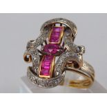 A yellow metal (tests 18 carat gold) synthetic ruby and diamond ring, head approx 2.