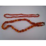A mixed lot comprising an amber necklace (51cm) and a coral necklace (40cm).