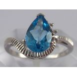 A white metal (tests 14 carat gold) blue topaz and diamond ring, topaz approx 9 x 6mm, ring size L,