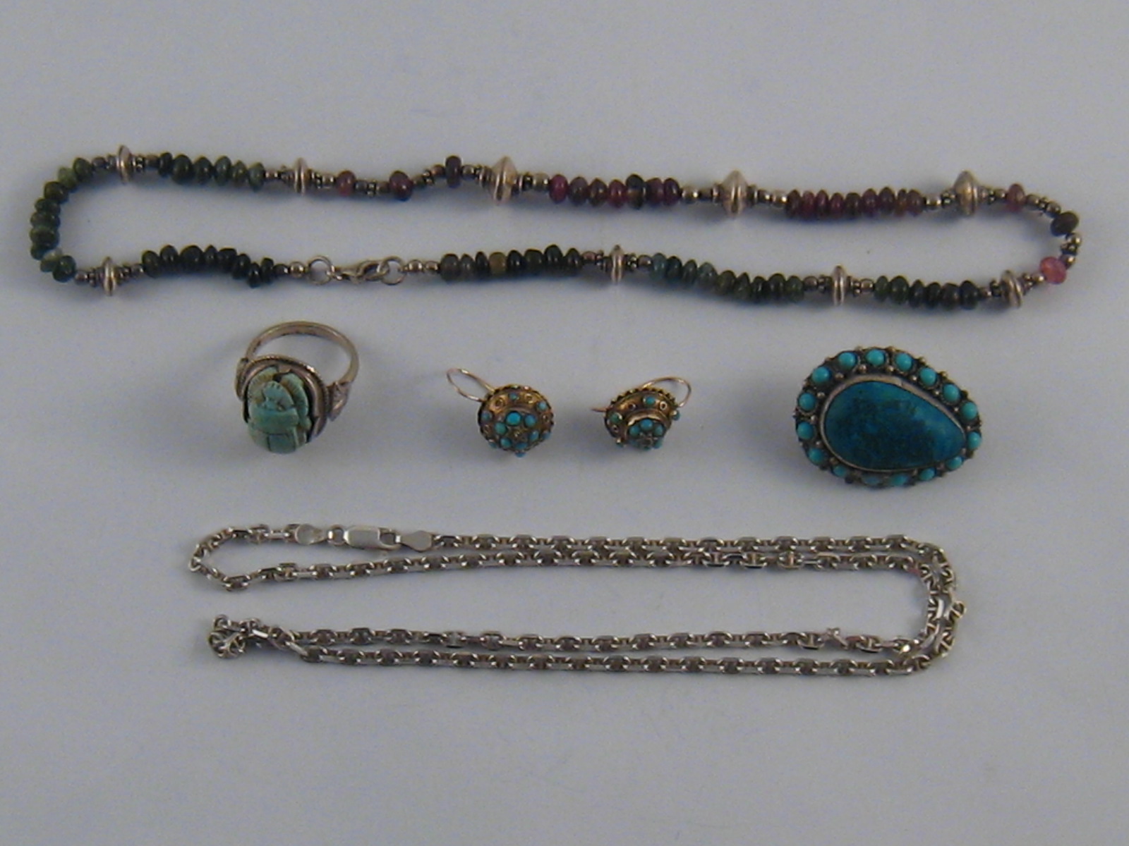 A mixed lot of white and gilt metal (tests silver) jewellery comprising a pair of antique turquoise