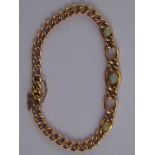 A yellow metal (tests 15 carat gold) opal bracelet, marked 15ct, central opal approx 5mm diameter,