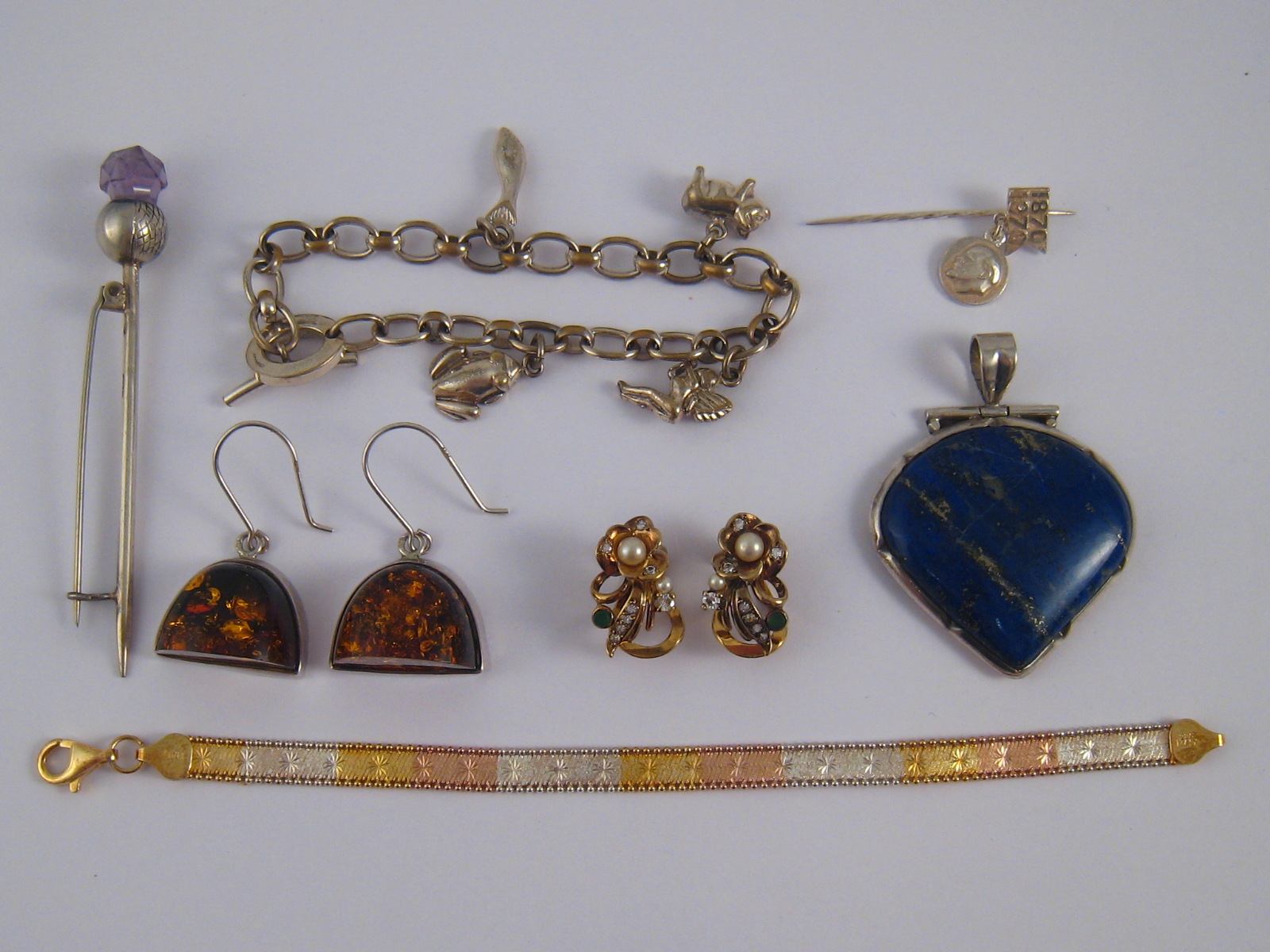 A mixed lot of white metal (tests silver) jewellery comprising a lapis lazuli pendant,