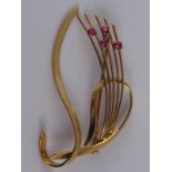 A yellow metal  (tests 14 carat gold) ruby brooch, approx 6cm, 8 gms.