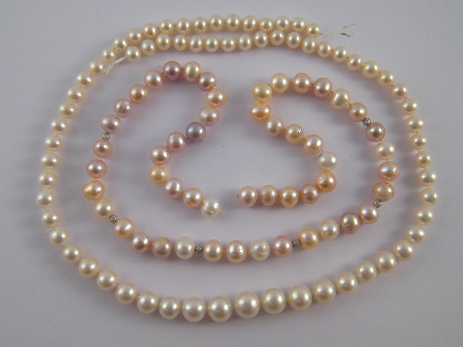 Two freshwater cultured pearl necklaces, lacking clasps, longest approx 49cm long.