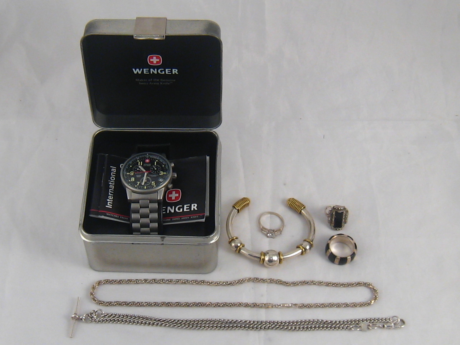 A mixed lot of white metal (tests silver) comprising a necklace chain, an Albert watch chain,