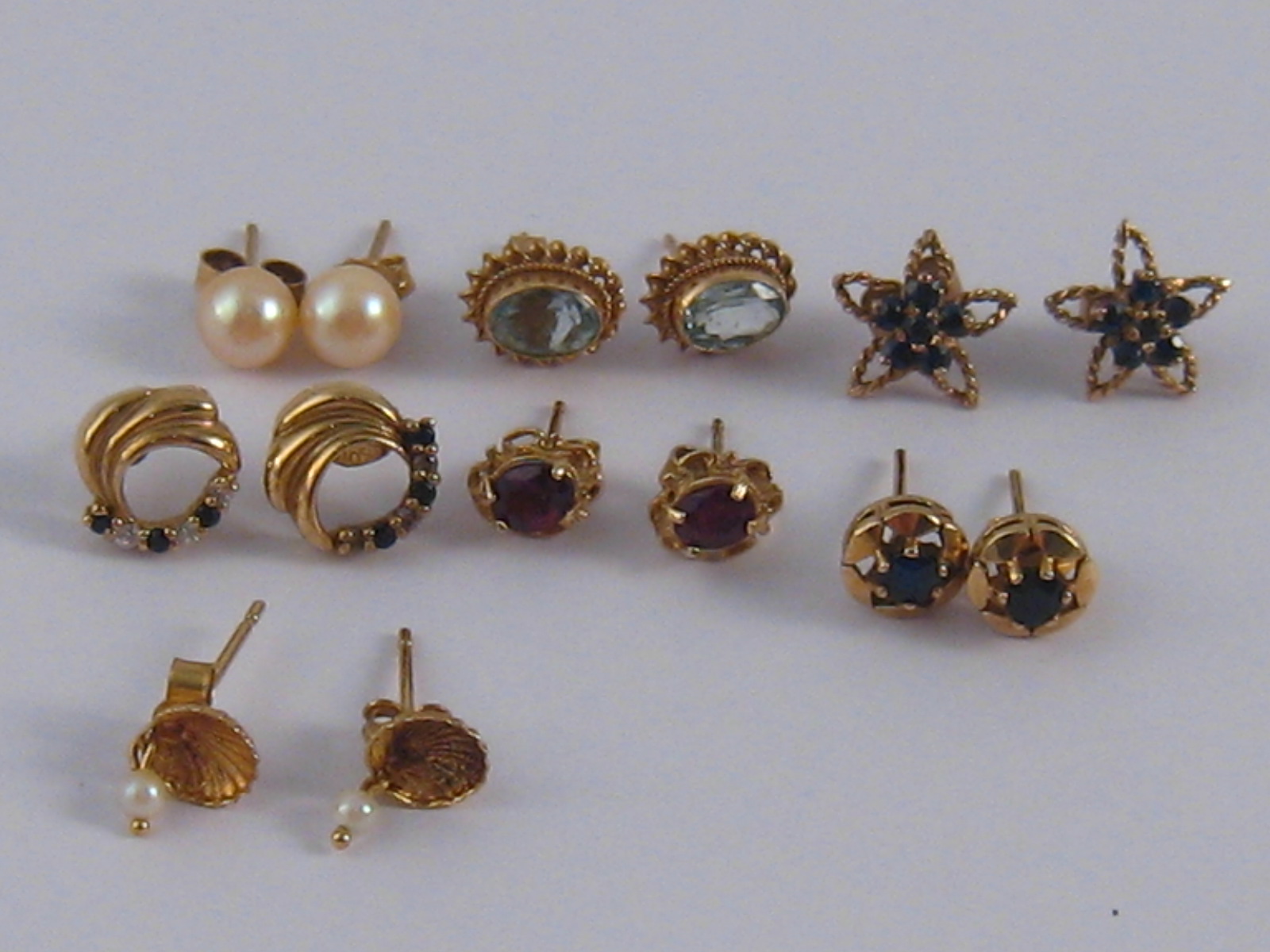 A mixed lot comprising seven pairs of 9 carat gold and yellow metal (tests 9 carat gold) ear studs.