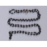 A black diamond necklace, approx 54cm long.