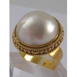 A yellow metal (tests 14 carat gold) mabe pearl ring, pearl approx 17mm diameter, ring size M, 11.