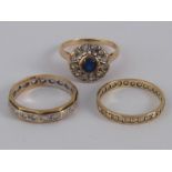A mixed lot comprising two 9 carat gold rings and a yellow metal (tests 9 carat gold) ring,