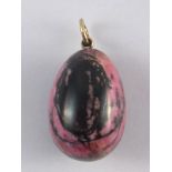 A large rhodonite egg , the suspension ring with Russian silver markings,  marks unclear. 2.5cm.