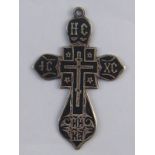 A Russian 19th. century silver niello filled cross with pendant loop. Length 6cm.