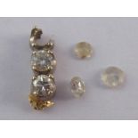 A mixed lot comprising five small loose polished diamonds.