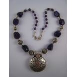 A white metal (tests silver) and amethyst necklace, central pendant approx 5cm,