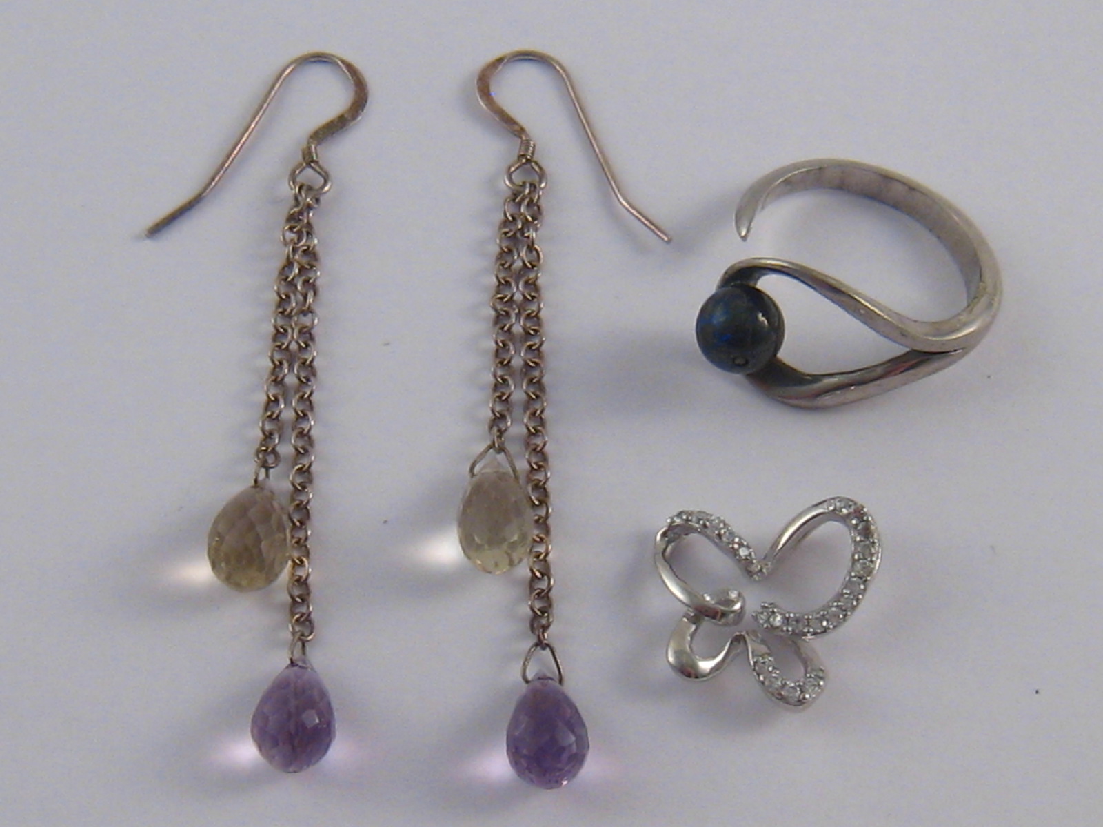 A mixed lot of white metal (tests silver) comprising a pair of drop earrings with citrines and
