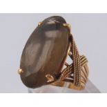 A yellow metal (tests 14 carat gold) smokey quartz ring, unascribed lyre hallmark,