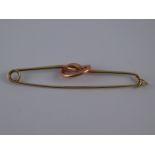 A two colour gold knot brooch, signed Cartier, numbered (rubbed) and stamped 14k, circa 1940,