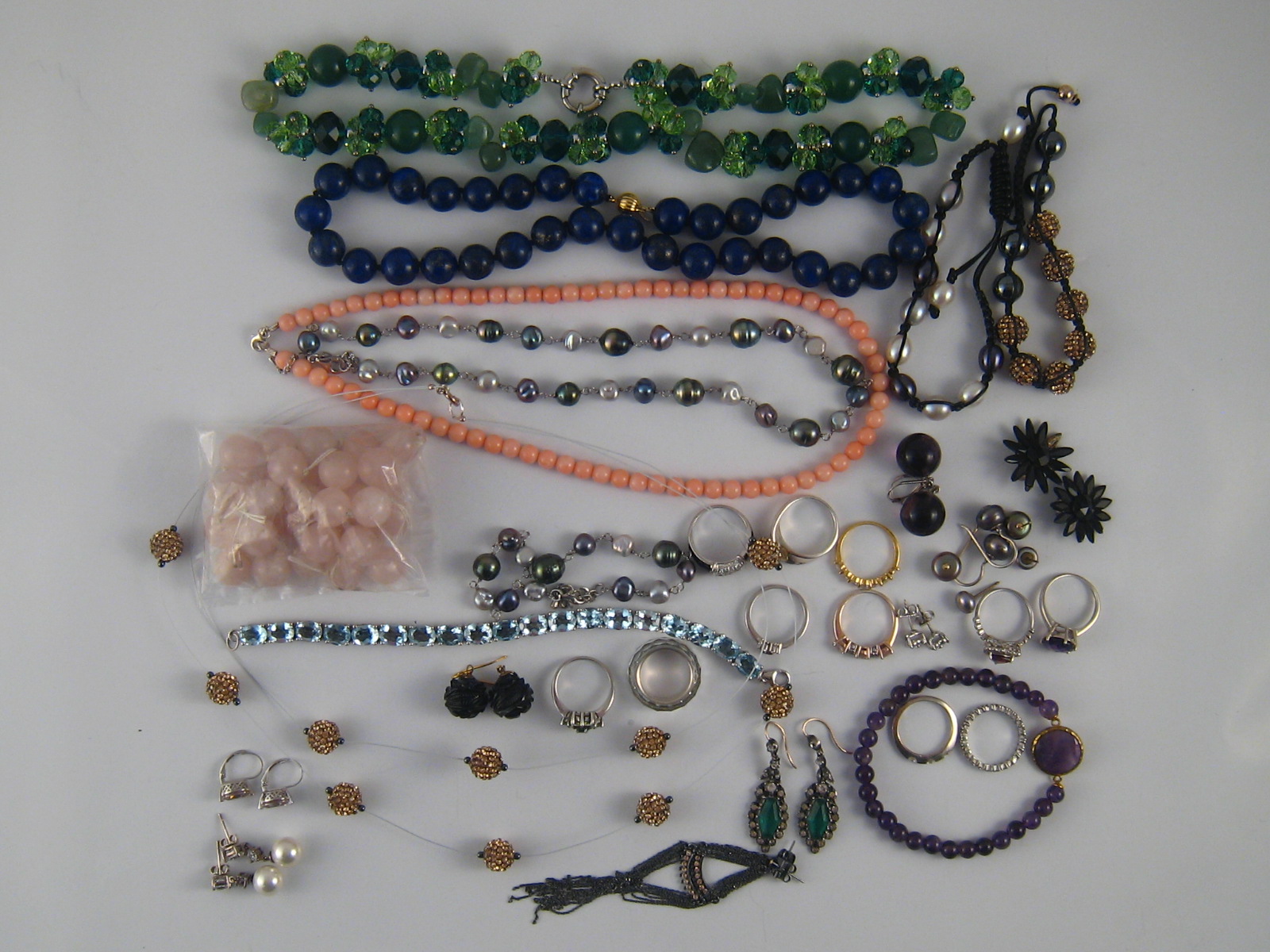 A mixed lot of white metal (tests silver) and costume jewellery including a diamond set ring,