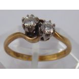 A 9 carat gold two stone diamond crossover ring, estimated diamond content approx 0.