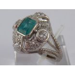 A French hallmarked 18 carat white gold and platinum emerald and diamond ring,