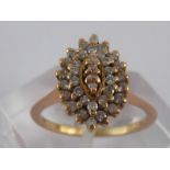 A yellow metal (tests 18 carat gold) diamond cluster ring, size L ½, 3.3 gms.