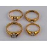 A mixed lot comprising four yellow metal (tests 18 carat gold) old brilliant cut diamond solitaitre