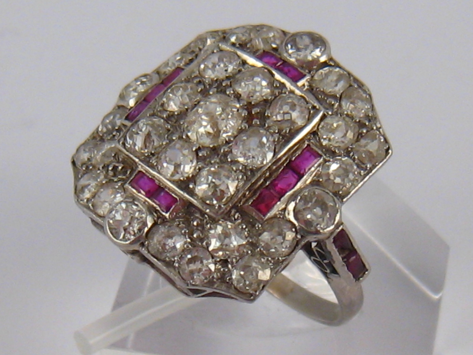 An Art Deco white metal (tests platinum) old brilliant cut diamond and ruby ring, circa 1930's,