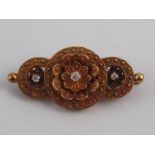 A Victorian 15 carat gold diamond brooch, the cushion cut diamonds of fine colour, approx 4.